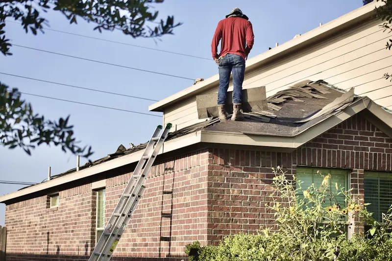 Professional roofer working on a residential roof in Aurora Highlands